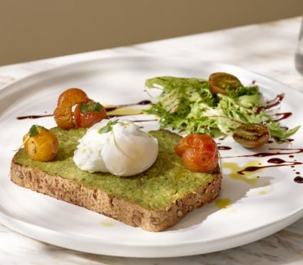 Pouched egg on pesto toast and roasted tomatoes at Tula