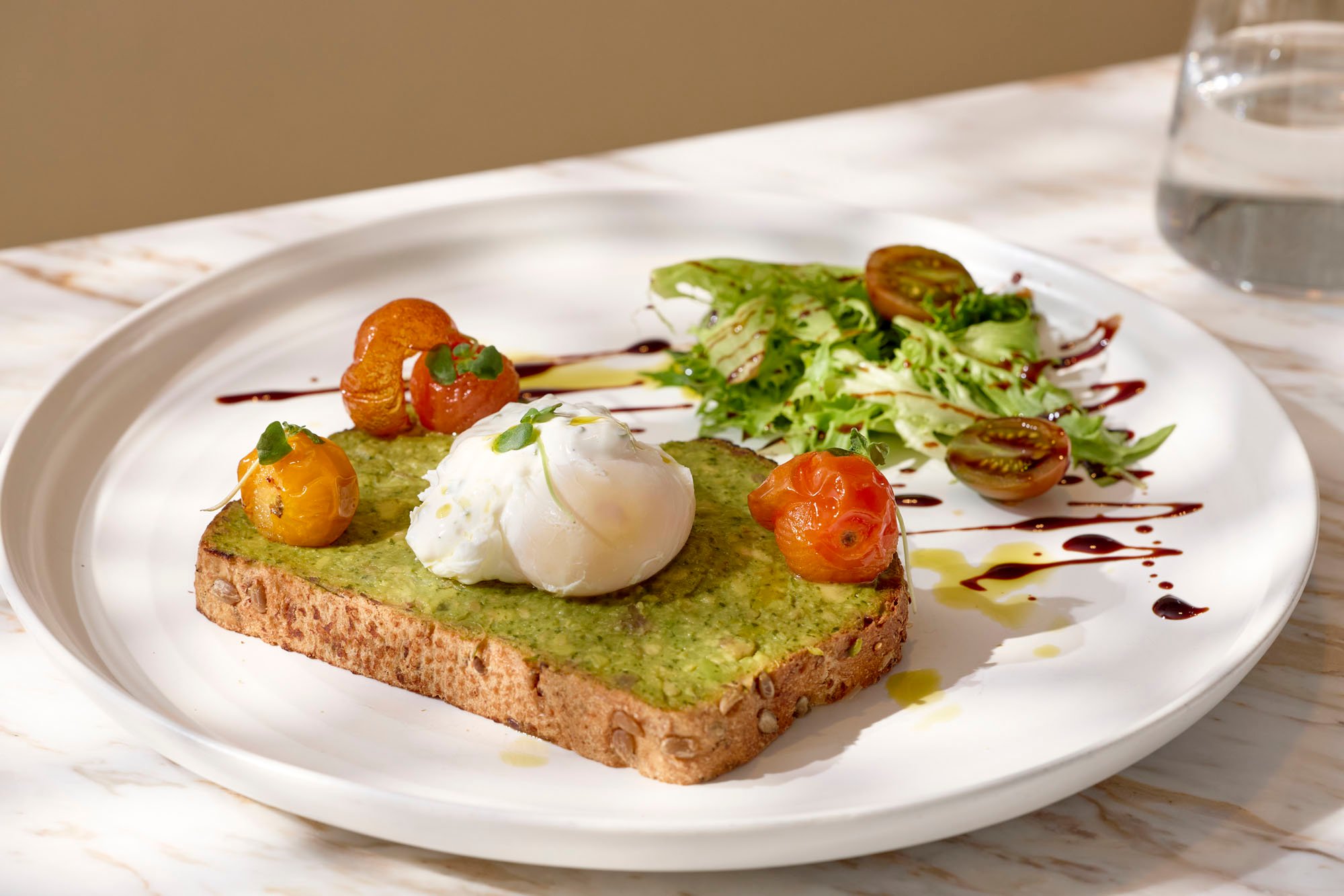 Pouched egg on pesto toast and roasted tomatoes at Tula