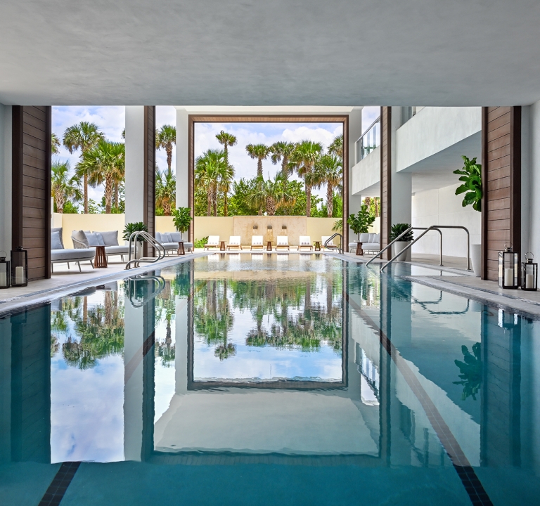 Serene outdoor spa pool surrounded by lush greenery at Amrit Ocean Resort’s wellness center
