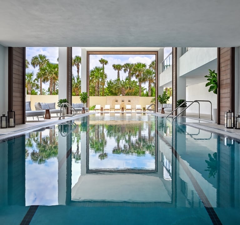 Serene outdoor spa pool surrounded by lush greenery at Amrit Ocean Resort’s wellness center