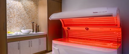 A TherLight spa treatment lit up with red light at Amrit Ocean Resort.