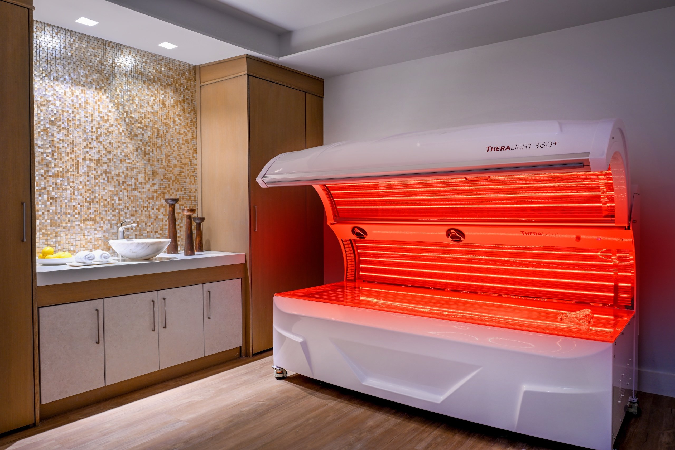 A TherLight spa treatment lit up with red light at Amrit Ocean Resort.