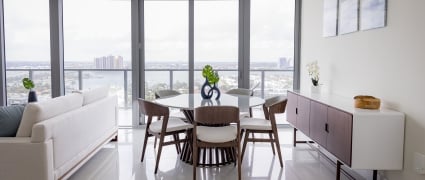 The dining space and floor to ceiling views of Riviera Beach, Florida in an intracoastal View Wellness Residence at the Amrit Ocean Resort
