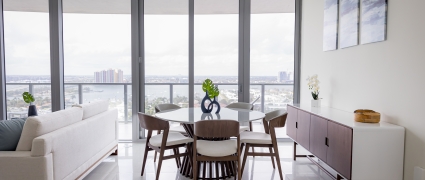 The dining space and floor to ceiling views of Riviera Beach, Florida in an intracoastal View Wellness Residence at the Amrit Ocean Resort