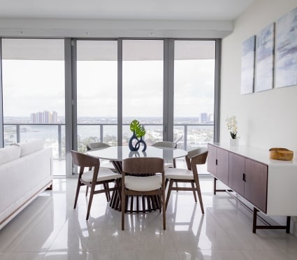 The dining space and floor to ceiling views of Riviera Beach, Florida in an intracoastal View Wellness Residence at the Amrit Ocean Resort