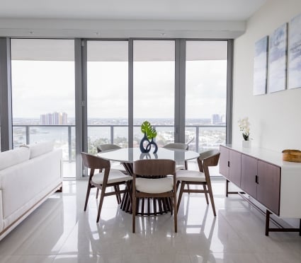 The dining space and floor to ceiling views of Riviera Beach, Florida in an intracoastal View Wellness Residence at the Amrit Ocean Resort