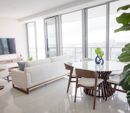 Dining and living area with floor-to-ceiling ocean views at Amrit Ocean Resort