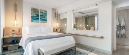 Bedroom and bathroom space of a junior suite king at Amrit Ocean Resort