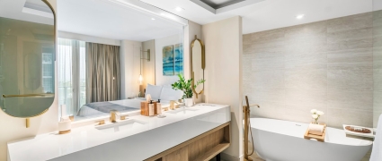 Washroom with a large vanity and soaker tub in a junior suite king at Amrit Ocean Resort