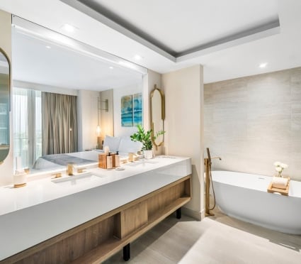 Washroom with a large vanity and soaker tub in a junior suite king at Amrit Ocean Resort