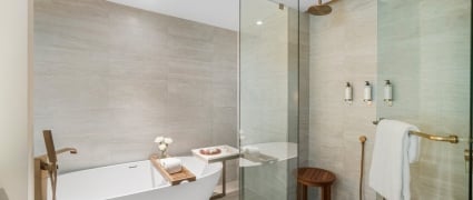 A soaker tub and shower in a junior suite king at Amrit Ocean Resort