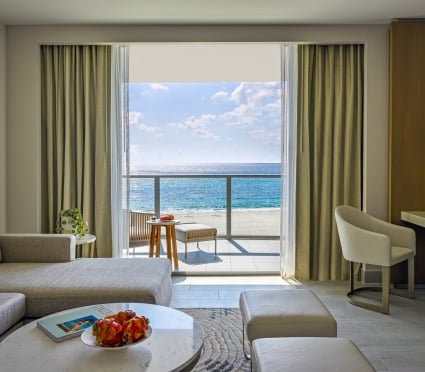 Spacious suite with king bed and ocean view balcony at Amrit Ocean Resort