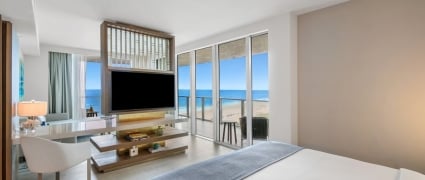 A view from the bedroom looking into the living space and the balcony of ocean view king room at the Amrit Ocean Resort
