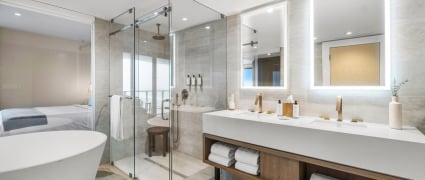 The washroom off of the bedroom with a soaker tub, shower and large vanity at the Amrit Ocean Resort