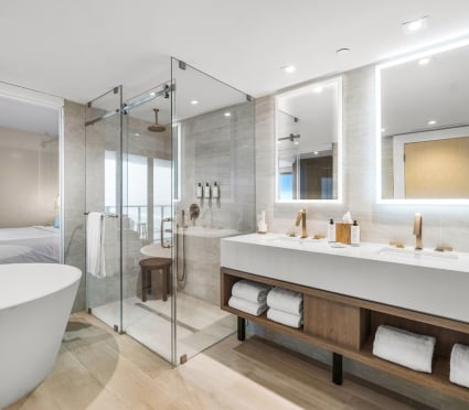 The washroom off of the bedroom with a soaker tub, shower and large vanity at the Amrit Ocean Resort