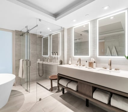 The washroom with a soaker tub, shower and vanity in an ocean view two queens room at the Amrit Ocean Resort
