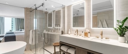 The washroom with a soaker tub, shower and vanity in an ocean view two queens room at the Amrit Ocean Resort