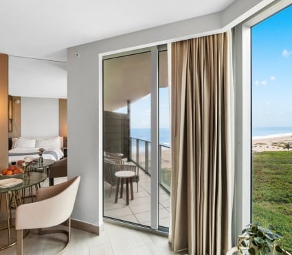 View of the beach and grassy area off the dining area in an ocean view two queens room at the Amrit Ocean Resort