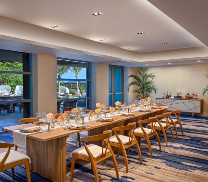 The Lotus event venue at Amrit Ocean Resort, a long banquet table set for a dinner.