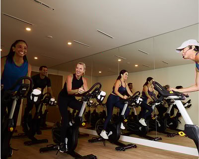 People attending a spin class at the Amrit Ocean Resort