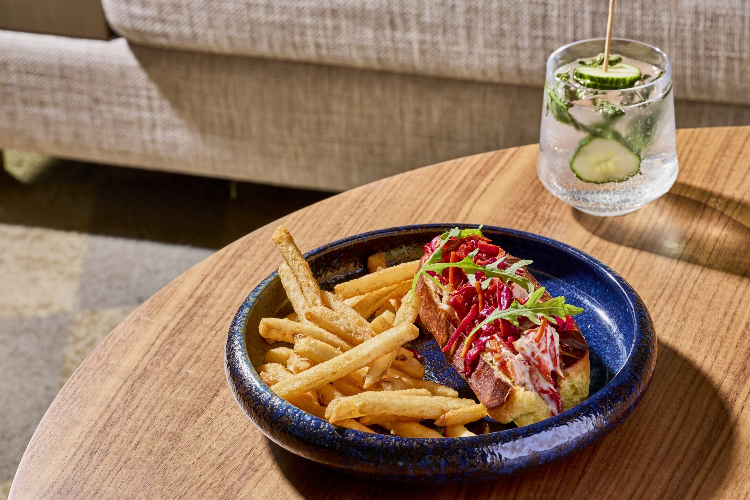 A lobster roll, fries and a cocktail at LALA