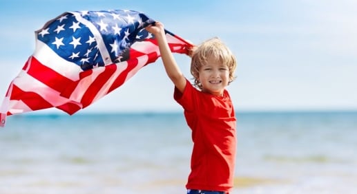 Boy on the beach with USA flag at Amrit Ocean Resort