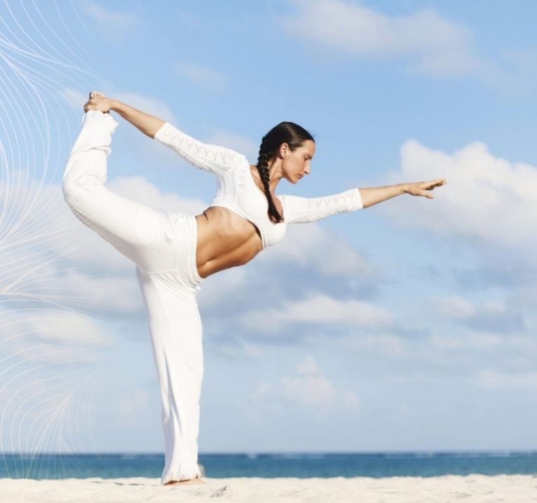 Girl doing Yoga on beach at Amrit Ocean Resort