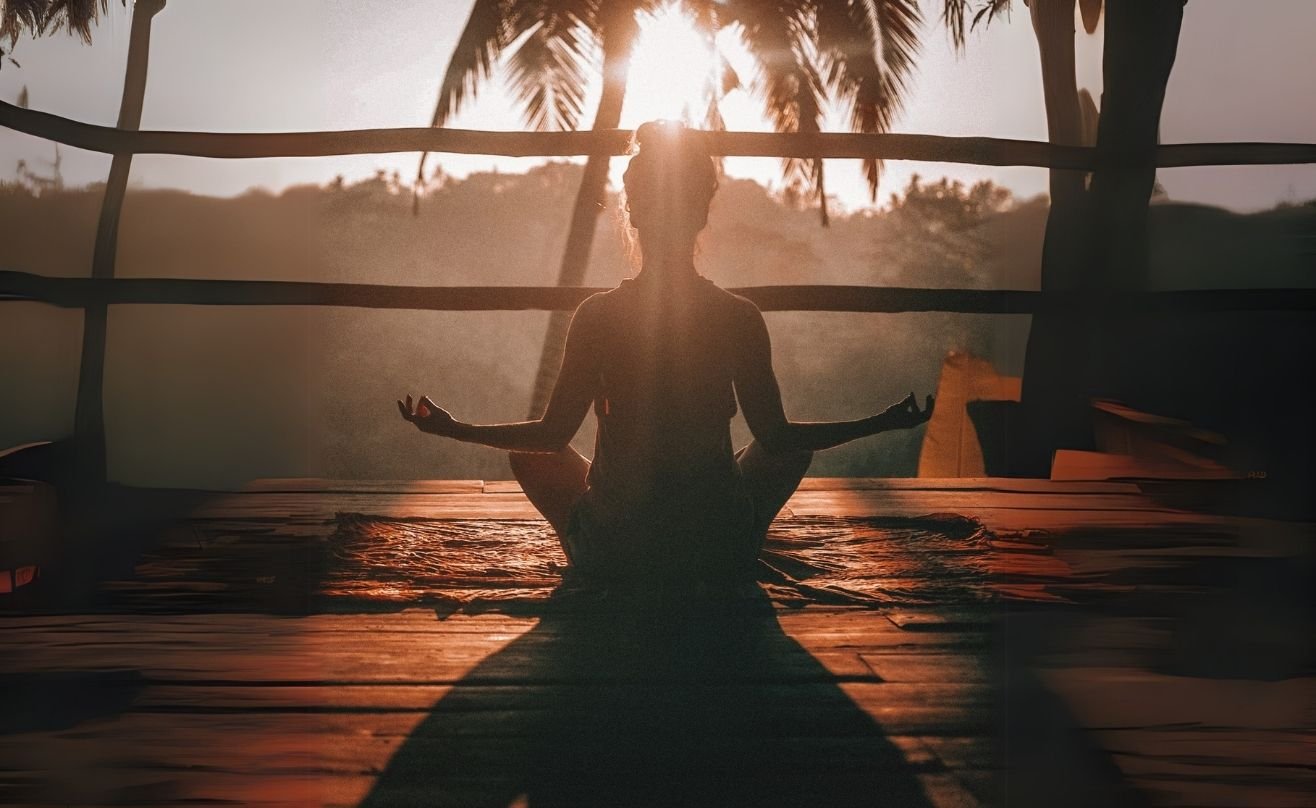 Lady doing yoga in front of sunset at Amrit ocean resort