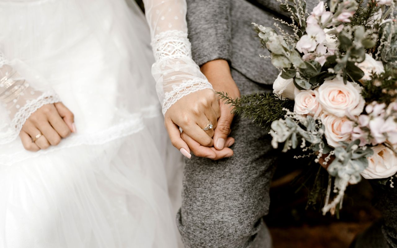 Close-up of an engaged hand with diamond ring during beach wedding at Amrit Ocean Resort