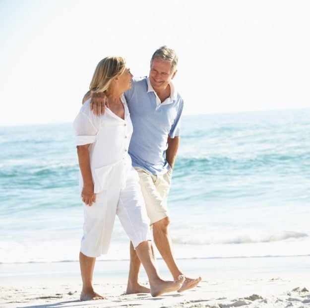 couple walking on a beach at Amrit ocean resort